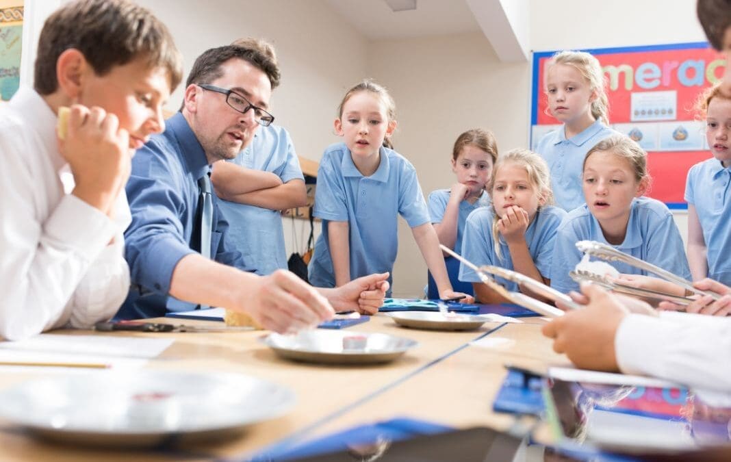 Children in classroom watching a science experiment.