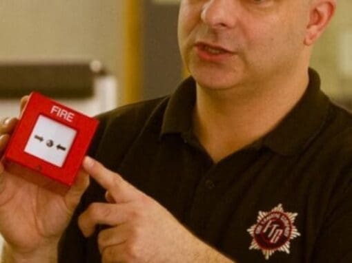 Nick the fire trainer demonstrating how a fire alarm works.