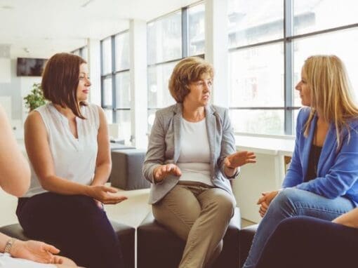 ladies sitting around in a group discussing an important topic