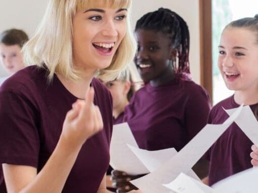 Lady running a choir with a group of children