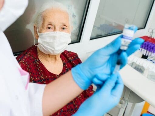 A lady being very careful with the control and prevention of infection by wearing a mask, gloves etc.