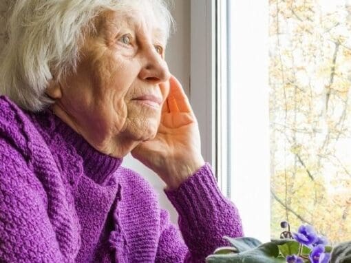 Elderly lady looking out of the window