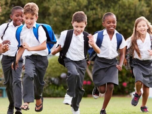 A group of children running on grass