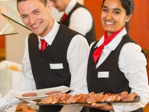 Picture of some smart servers serving food.