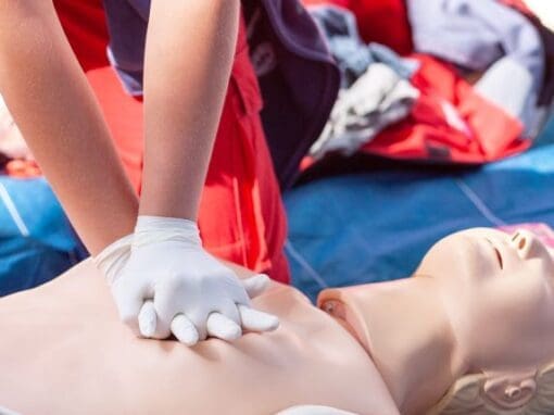 Somebody practicing CPR on a dummy