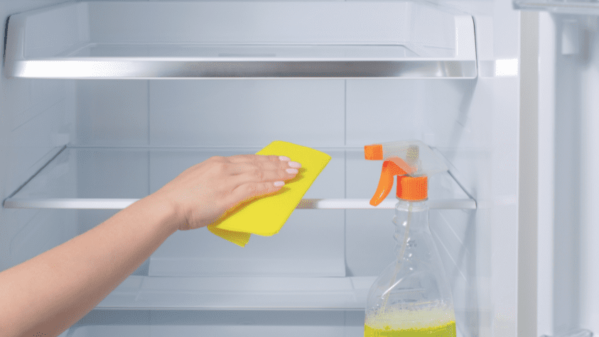 Somebody cleaning a fridge