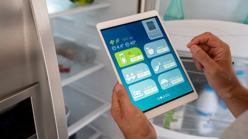 Somebody checking a fridge temperature with a device