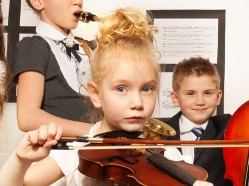 School children playing musical instruments.